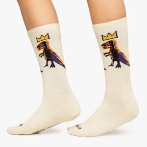 Step out in style with the Basquiat Pez Dispenser - Athletic socks—cream-coloured and adorned with a crowned dinosaur, accented in red, purple, and black—perfect for unique finds while Tallinn shopping or visiting a concept shop. Gate21.ee