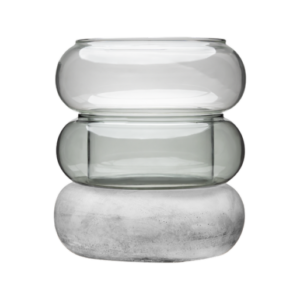The Bagel - Candleholder - Teal features three rounded, stackable forms: two are transparent glass in varying shades, and the solid base resembles smooth light grey concrete. All are arranged vertically for a modern look. Gate21.ee