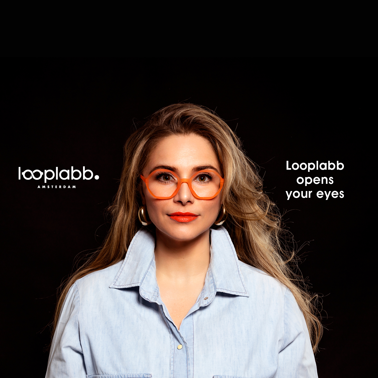 A woman with long blonde hair wears FAUST - Black spectacles and a light blue button-up shirt, facing the camera against a black background. White text reads: Looplabb opens your eyes to Estonian design and unique ideas at Looplabb Amsterdam. Gate21.ee