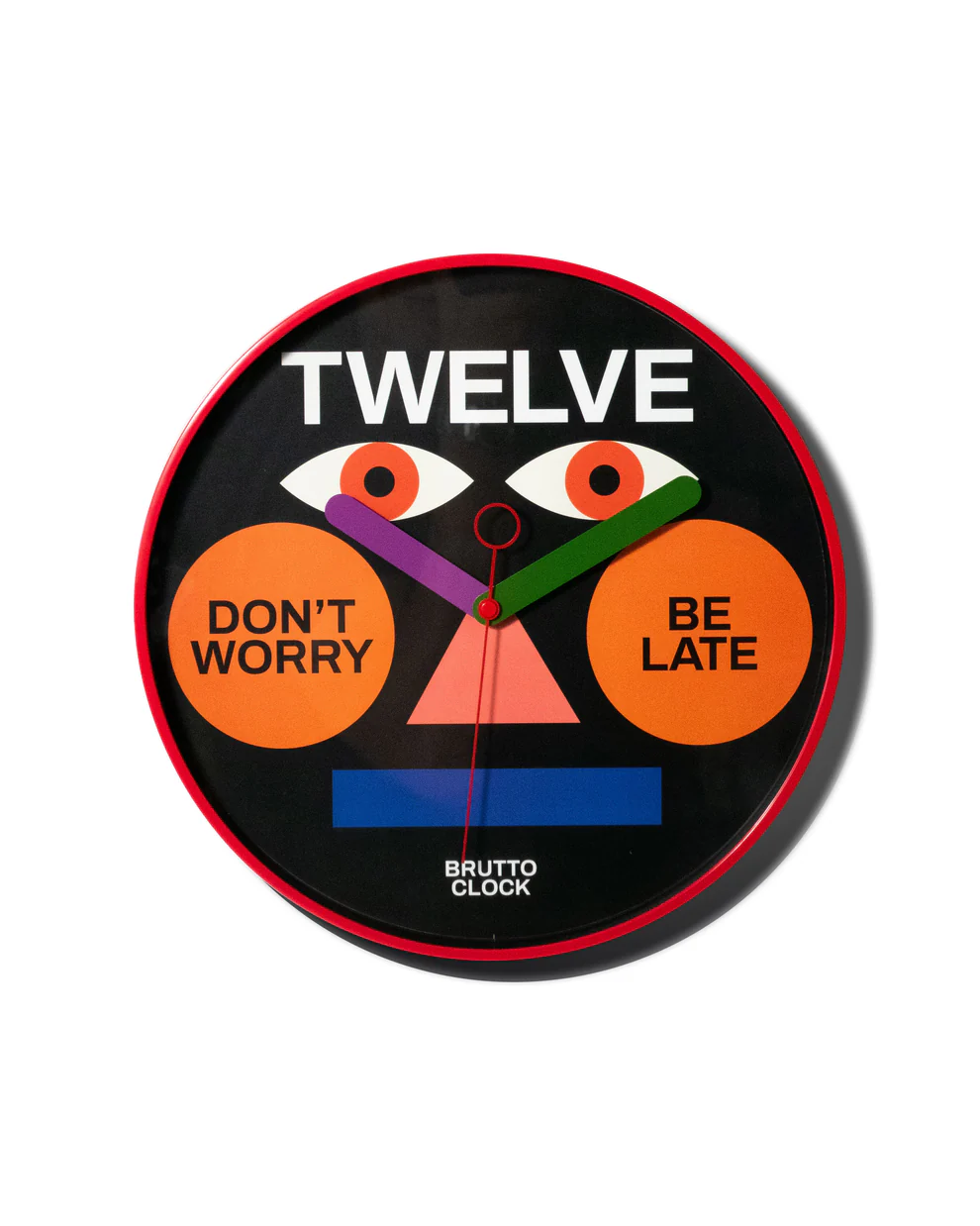The BE LATE - Wall clock boasts a bold red rim and black face, Estonian-designed with geometric shapes and quirky text accents including TWELVE at the top—an eye-catching piece ideal for any modern concept shop. Gate21.ee