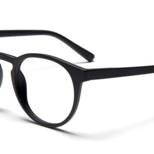The PAPILLON - Black eyeglasses, featuring round clear lenses and designed in Estonia, rest on a white surface angled right—an elegant statement for any concept shop. Gate21.ee