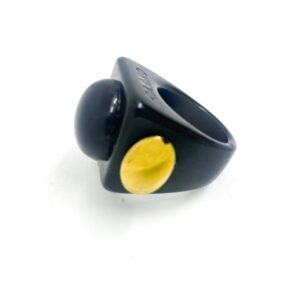 The Gra o Tron - Ring is a black chunky ring with a large round black dome on top and a small yellow accent on the side, perfect for those seeking unique concept shop ideas. Displayed against a plain white background. Gate21.ee