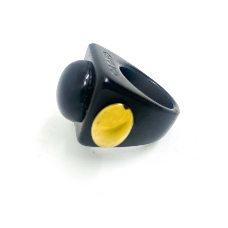 The Gra o Tron - Ring is a black chunky ring with a large round black dome on top and a small yellow accent on the side, perfect for those seeking unique concept shop ideas. Displayed against a plain white background. Gate21.ee
