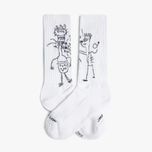 The Basquiat TKO - Athletic socks are white crew socks from a curated gift shop, featuring black sketch-style crowned figures and "LION" and "JAN" near the toes, showcasing unique Estonian design. Gate21.ee