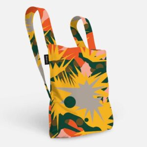 The Spark is a reusable fabric tote bag with two handles, featuring curated Estonian design in bold yellow, green, orange, and pink on white. Its rectangular shape and small black side tag make it perfect for shopping in Tallinn. Gate21.ee