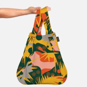 A hand holds Spark, a reusable shopping bag with an abstract pattern in green, yellow, and orange. With two handles and a small black tag, this stylish accessory is ideal for Tallinn shopping or trips to your favourite concept store. Gate21.ee
