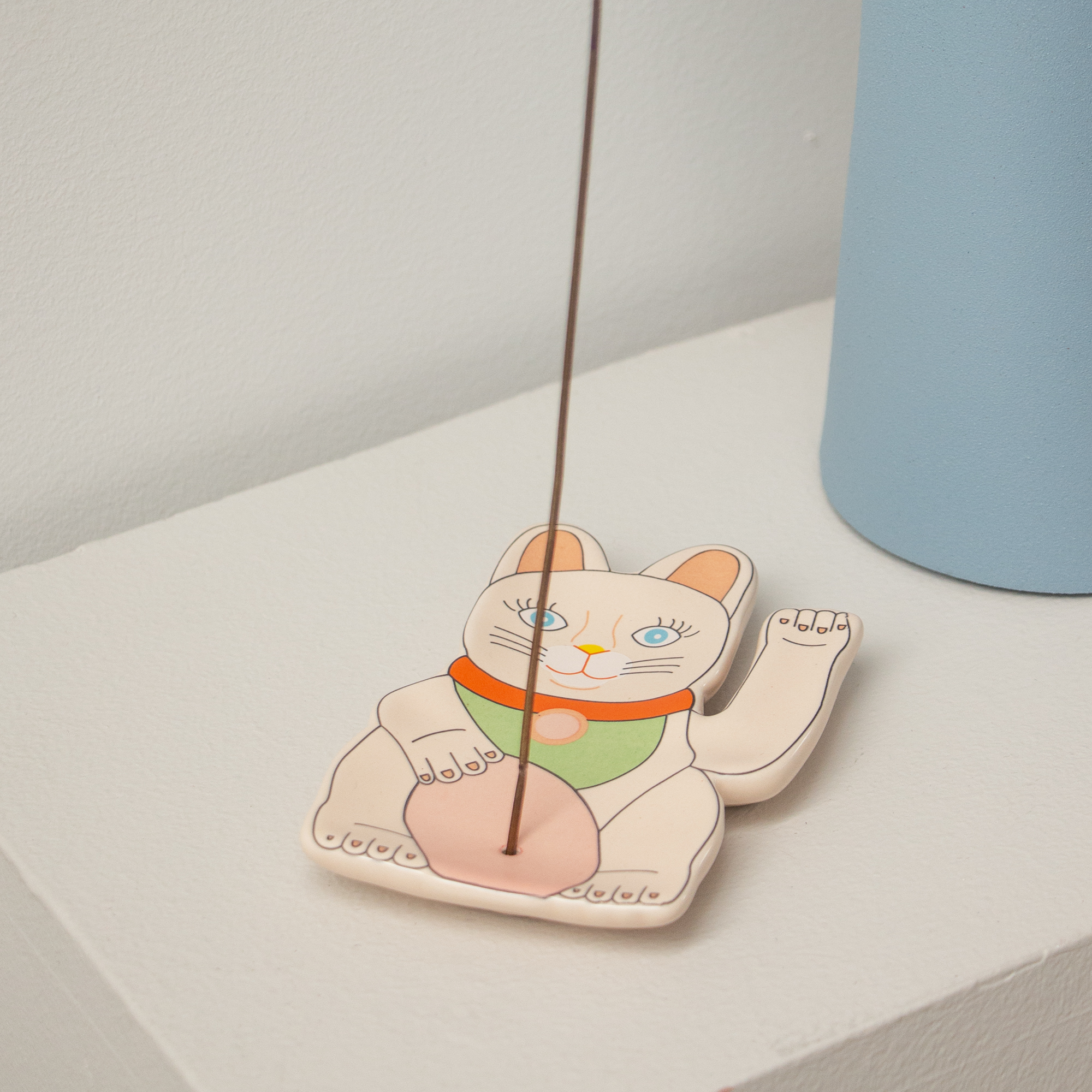 The Incense burner - Lucky Cat is a ceramic holder shaped like a maneki-neko, designed to hold incense upright—ideal for curated gift shops or anyone shopping in Tallinn. Gate21.ee