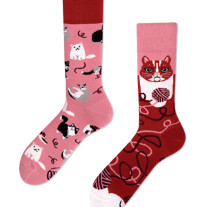 Playful Cats socks showcase curated Estonian design: one pink sock with playful cats and wool, the red sock with a bold cat face and wool patterns—a charming find for Tallinn shoppers. Gate21.ee