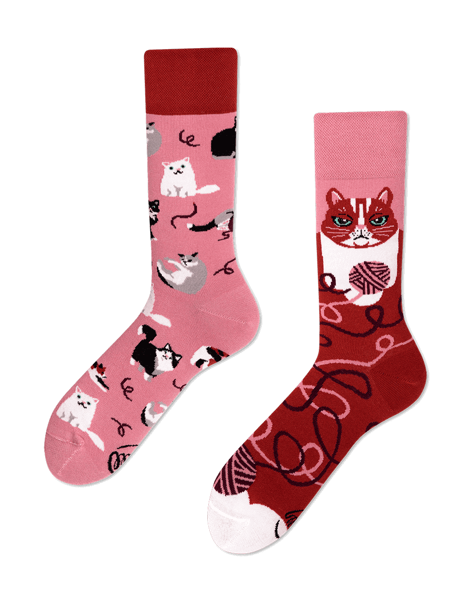 Playful Cats socks showcase curated Estonian design: one pink sock with playful cats and wool, the red sock with a bold cat face and wool patterns—a charming find for Tallinn shoppers. Gate21.ee