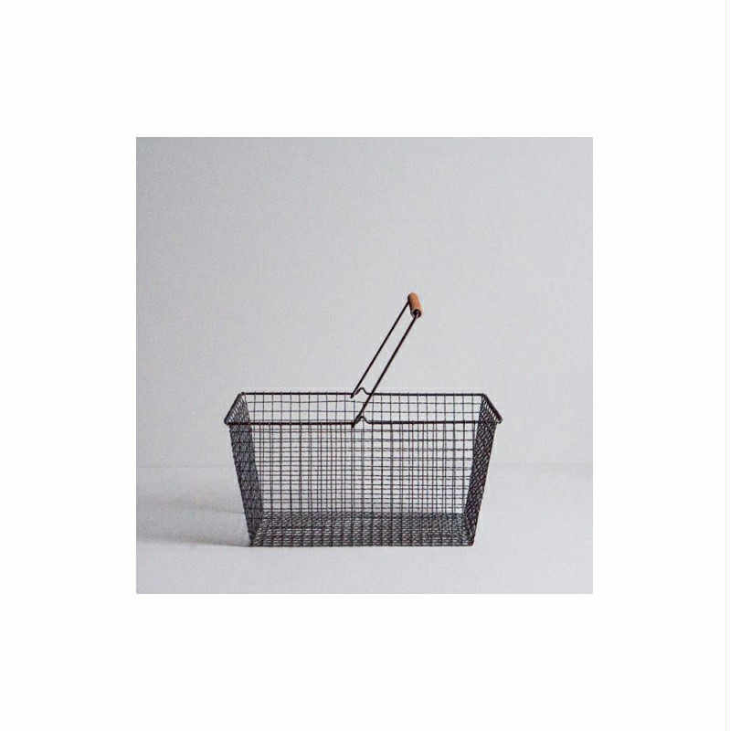 The Baskets wire shopping basket features a rectangular shape, metal handle with wooden grip, ideal for curated gift shops, displayed on a plain white surface with a white background. Gate21.ee