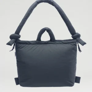 The Ona Soft Bag - Coal is a dark grey padded tote with one large knotted handle and one small handle, shown on a plain background—ideal for your next Tallinn shopping trip or as a striking addition to your concept shop collection. Gate21.ee