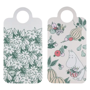 The Moomin chopping and serving boards - Seasonal Delicacies set includes two handled boards: one with a green floral pattern hiding cartoon characters, and one with Moomins among fruit and vegetables on a beige background. Gate21.ee