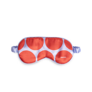 The Eye Mask - Scarlet Dot features a silk front with red and lavender polka dots, a lavender band, and “MAGIQUE” in white—an elegant Estonian design ideal for Tallinn shopping or as a unique present. Gate21.ee