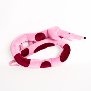 The Pink Dachshund - Large Cushion, inspired by Estonian design, is a soft, plush toy with dark red spots and a pointed snout—perfect as an adorable and charming addition to any gift shop. Gate21.ee