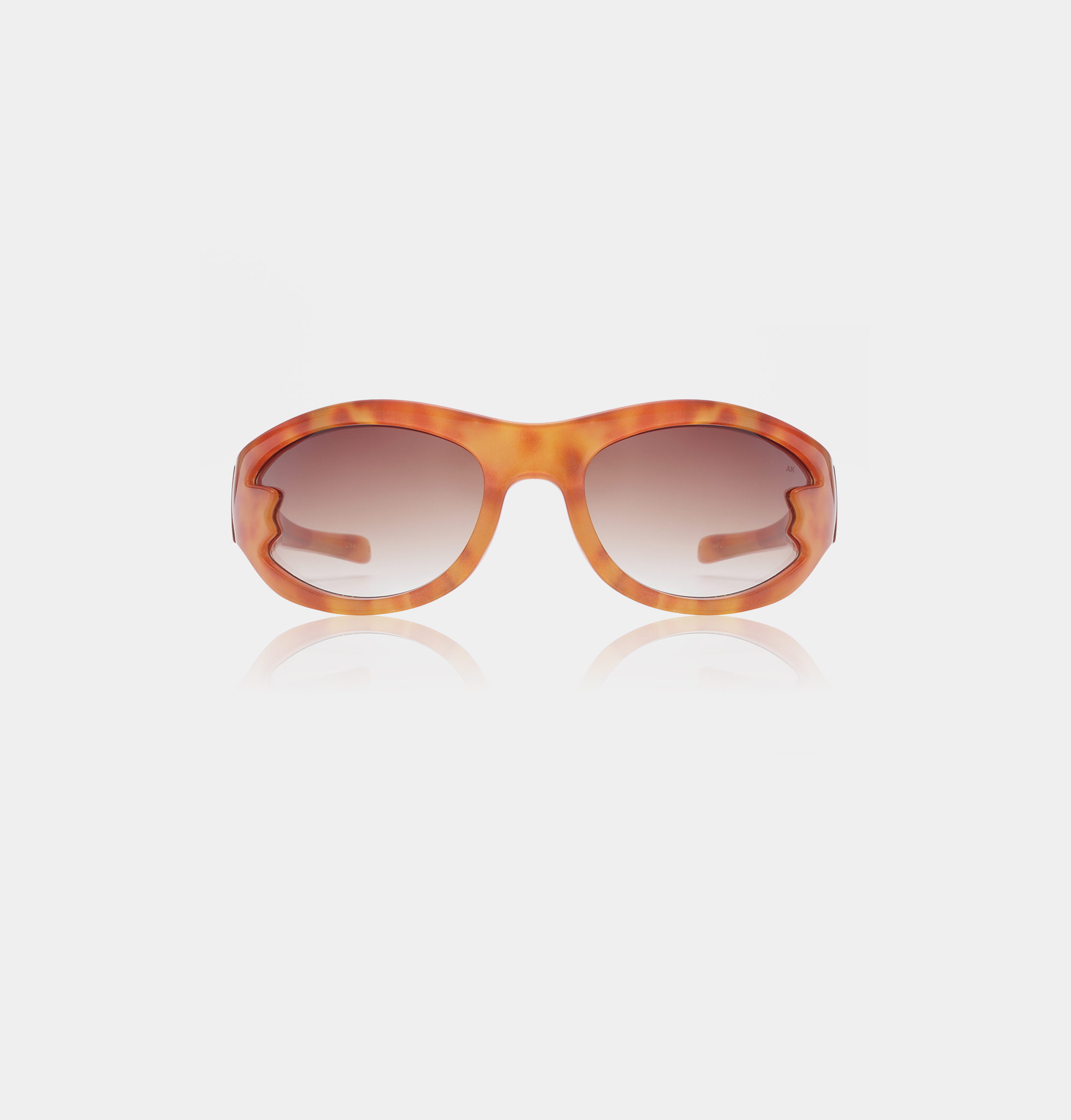 Front view of BLAST - Burnt Amber sunglasses featuring oversized oval frames in a tortoiseshell orange pattern with brown gradient lenses, highlighting curated Estonian design against a plain white background. Gate21.ee