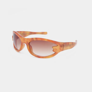 BLAST - Burnt Amber sunglasses feature orange and brown tortoiseshell frames, oval lenses, and a unique cut-out on the upper outer edge of the right frame, inspired by Estonian design. Displayed on a white background. Gate21.ee