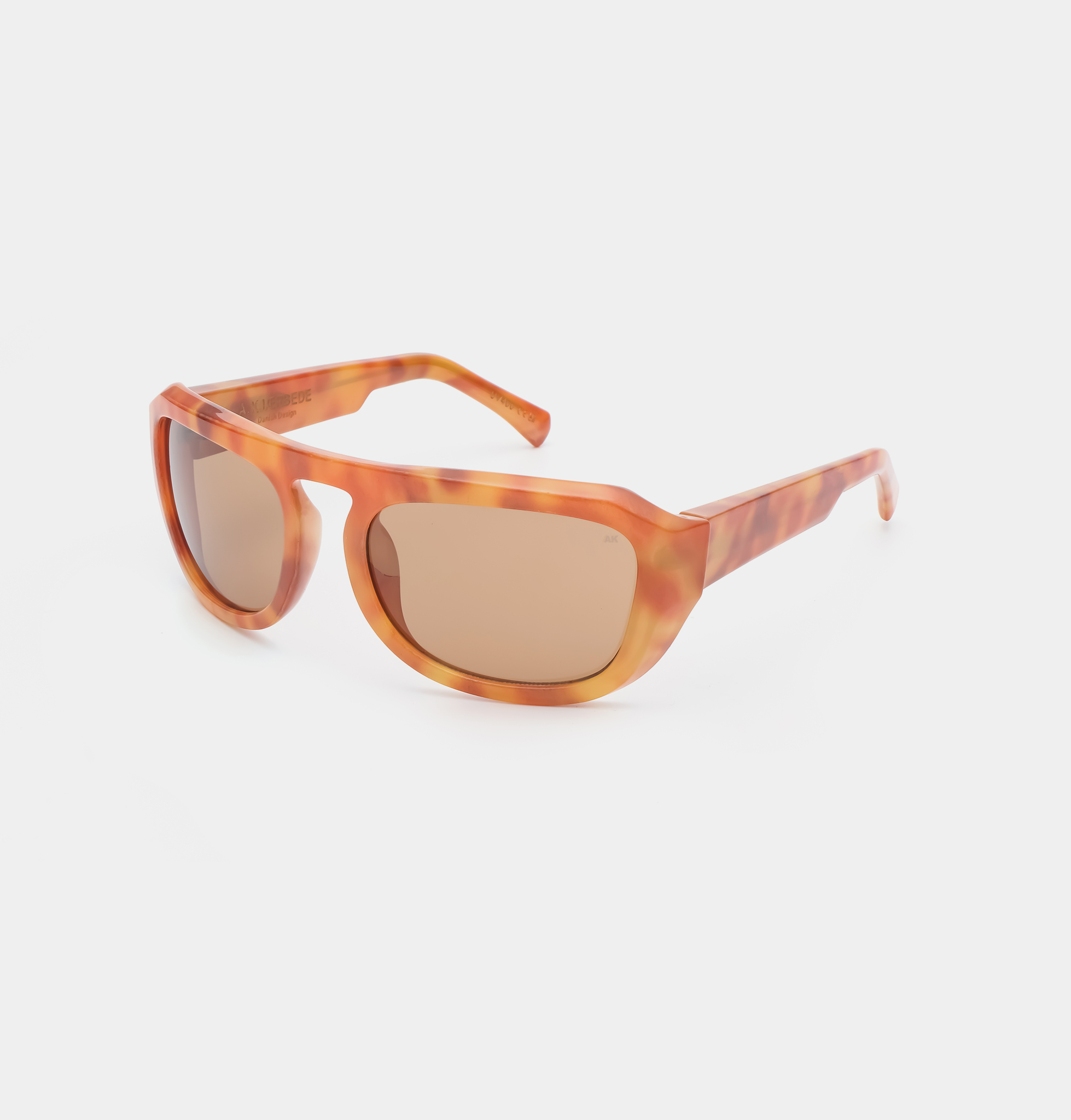 MAX - Burnt Amber sunglasses feature a bold, rounded orange tortoiseshell frame with thick arms and brown-tinted lenses, shown on a plain white background—ideal for those seeking unique, curated pieces from a standout concept shop. Gate21.ee