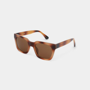 The NANCY - Demi Brown sunglasses feature a brown tortoiseshell square frame with dark brown lenses, glossy finish, and curved arms, styled against a white background. A chic choice often seen in Tallinn’s curated gift shops and concept stores. Gate21.ee