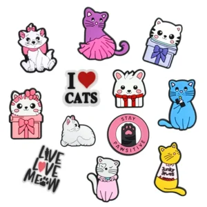 The Charm Stickers + Croc set features eleven curated cartoon cat illustrations in various poses and colours, including cats with objects, plus text graphics like "I love cats," all reflecting unique Estonian design. Gate21.ee