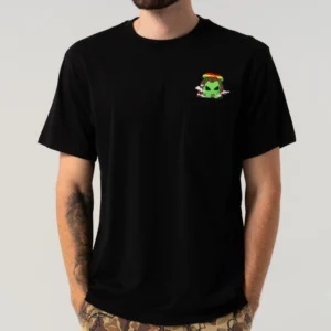 A person wearing the Smoking Rasta Alien Pocket T-shirt - Black with a small green alien in sunglasses and a red-yellow hat on the pocket, paired with camo trousers—ideal for an Estonian design gift shop or concept store. Gate21.ee