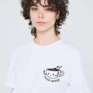 A person with short curly hair wears a white "Suck it Tequila" T-shirt featuring a bold tequila-themed graphic and slogan printed on the left chest—a standout gift shop find for those seeking unique and edgy clothing. Gate21.ee