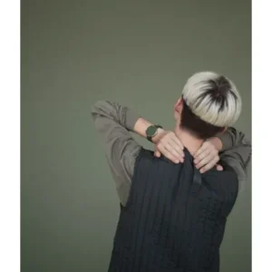 A person with short, two-toned hair is seen from behind, wearing a long-sleeved shirt and waistcoat, hands on their neck—a striking scene to showcase the Olive / Olive / 40mm in a concept store or gift shop focused on modern style. Gate21.ee