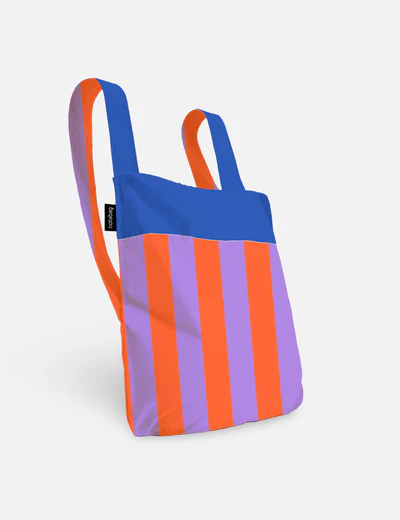 The "Royal Stripes - Special Edition" tote bag features vertical orange and purple stripes on the front, a solid blue top, matching handles, and a black brand tag—a striking Estonian-inspired piece ideal for any gift shop. Gate21.ee