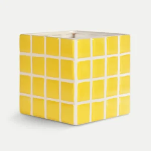 The Planter Tile - Yellow (14 x 14 x 14 cm) is a ceramic, cube-shaped planter featuring a grid of yellow squares with white lines, exemplifying curated Estonian design. An opening at the top makes it ideal for plants or creative display. Gate21.ee