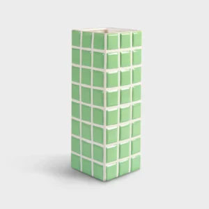 The Vase Tile - Mint (10.5 x 10.5 x 28 cm) features a tall, rectangular ceramic form with raised green squares outlined in white, reflecting distinctive Estonian design, set against a plain light grey background. Gate21.ee