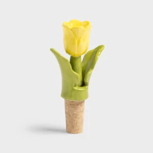 The Bottle Stopper Tulip - Yellow (7 x 3.5 x 12 cm) features a cork base and ceramic top shaped as a yellow tulip with green leaves—ideal for unique gifts or memorable Tallinn shopping finds. Gate21.ee