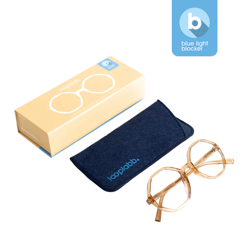 Featuring LOLITA - Blue Light - Crystal Champagne 0.0 glasses with a transparent frame, navy blue soft Topplab. case, and illustrated beige box—ideal for sparking creativity at Tallinn’s coolest concept shop. Blue light blocker icon displayed above. Gate21.ee