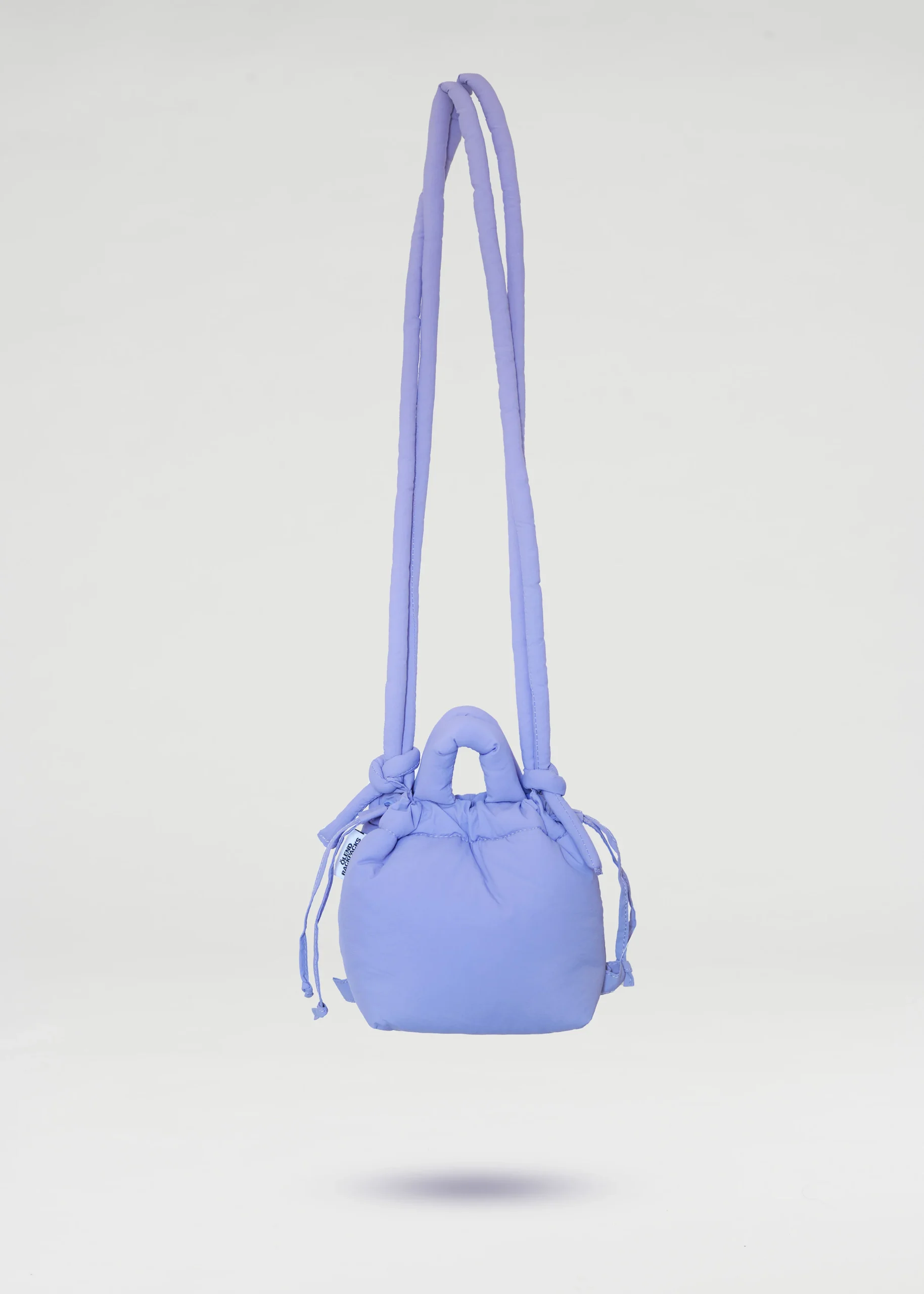 The Micro Ona Soft Bag - Lilac, a small shoulder bag with a long strap and drawstring sides inspired by Estonian design, is displayed against a plain white background. Gate21.ee
