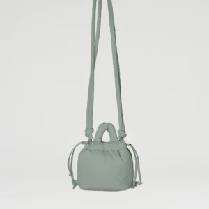 The Micro Ona Soft Bag - Sage is a small, light green rectangular crossbody with long strap, short handles, and drawstring sides—ideal for Tallinn shopping or unique style ideas—shown against a plain white background. Gate21.ee