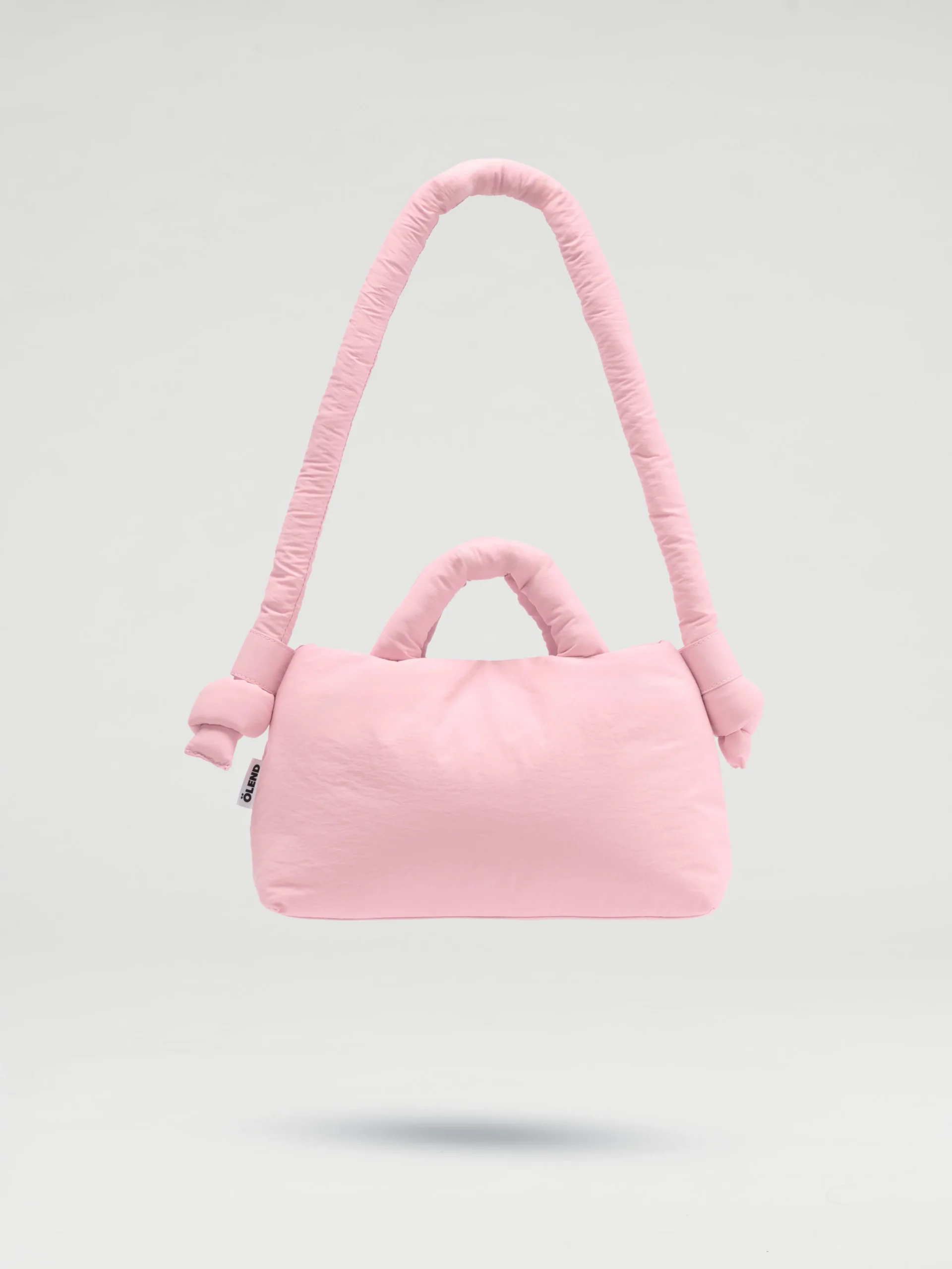 The Mini Ona Soft Bag - Pale Pink is a light pink padded handbag with a plush texture, thick curved shoulder strap, and two short handles, highlighting Estonian design against a plain light grey background. Gate21.ee