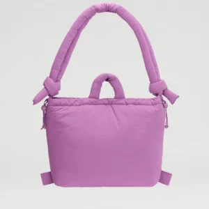 The Ona Soft Bag - Grape is a padded, rectangular tote in light purple with thick, rounded handles and knotted side details, showcasing curated Estonian design. Photographed against a plain white background. Gate21.ee
