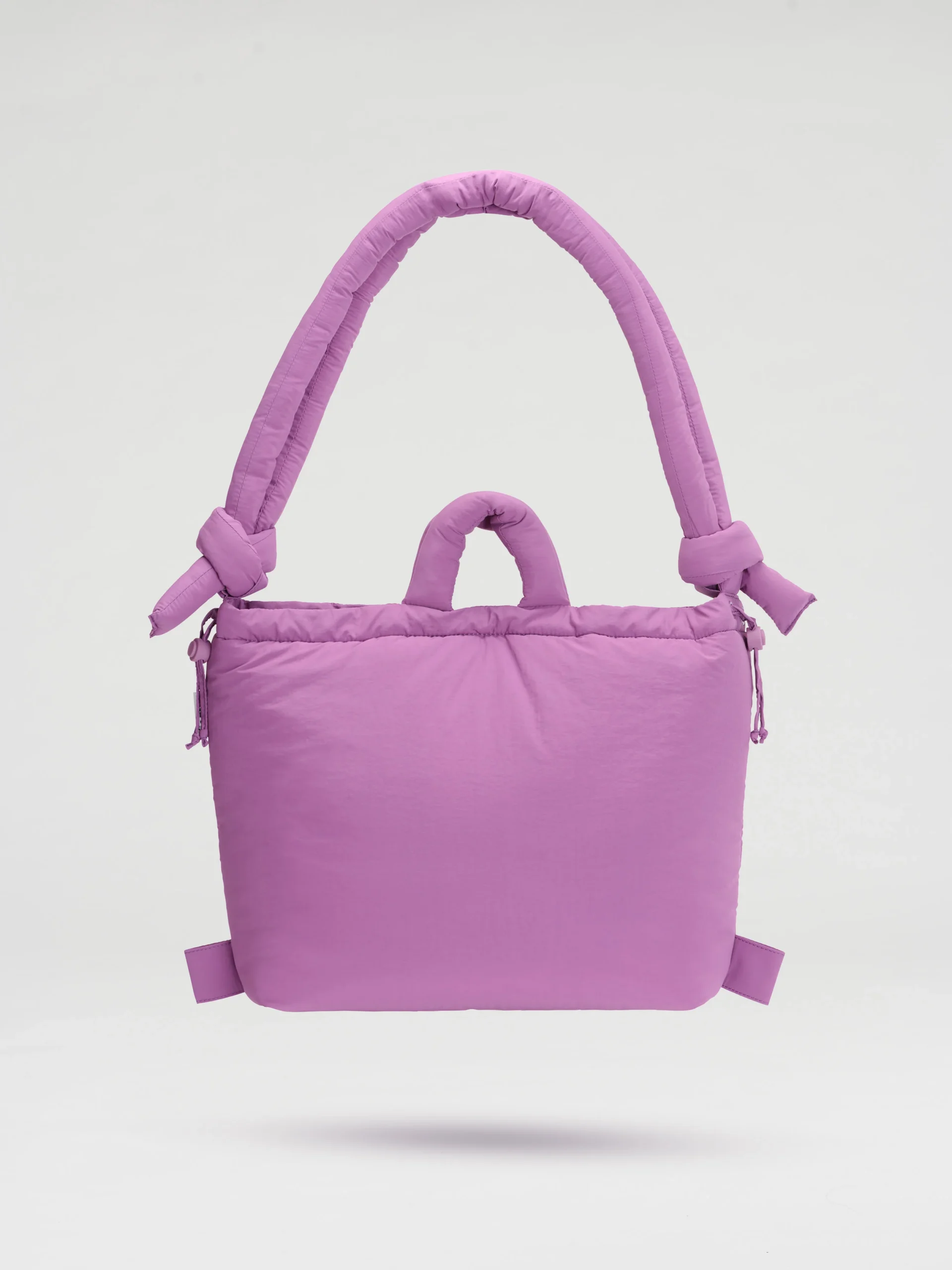 The Ona Soft Bag - Grape is a padded, rectangular tote in light purple with thick, rounded handles and knotted side details, showcasing curated Estonian design. Photographed against a plain white background. Gate21.ee