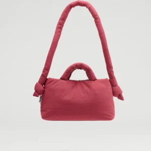 The Mini Ona Soft Bag - Cherry Red, featuring padded handles and a cushioned shoulder strap, stands out against a white background—an on-trend accessory you’d find in a stylish Tallinn concept shop. Gate21.ee