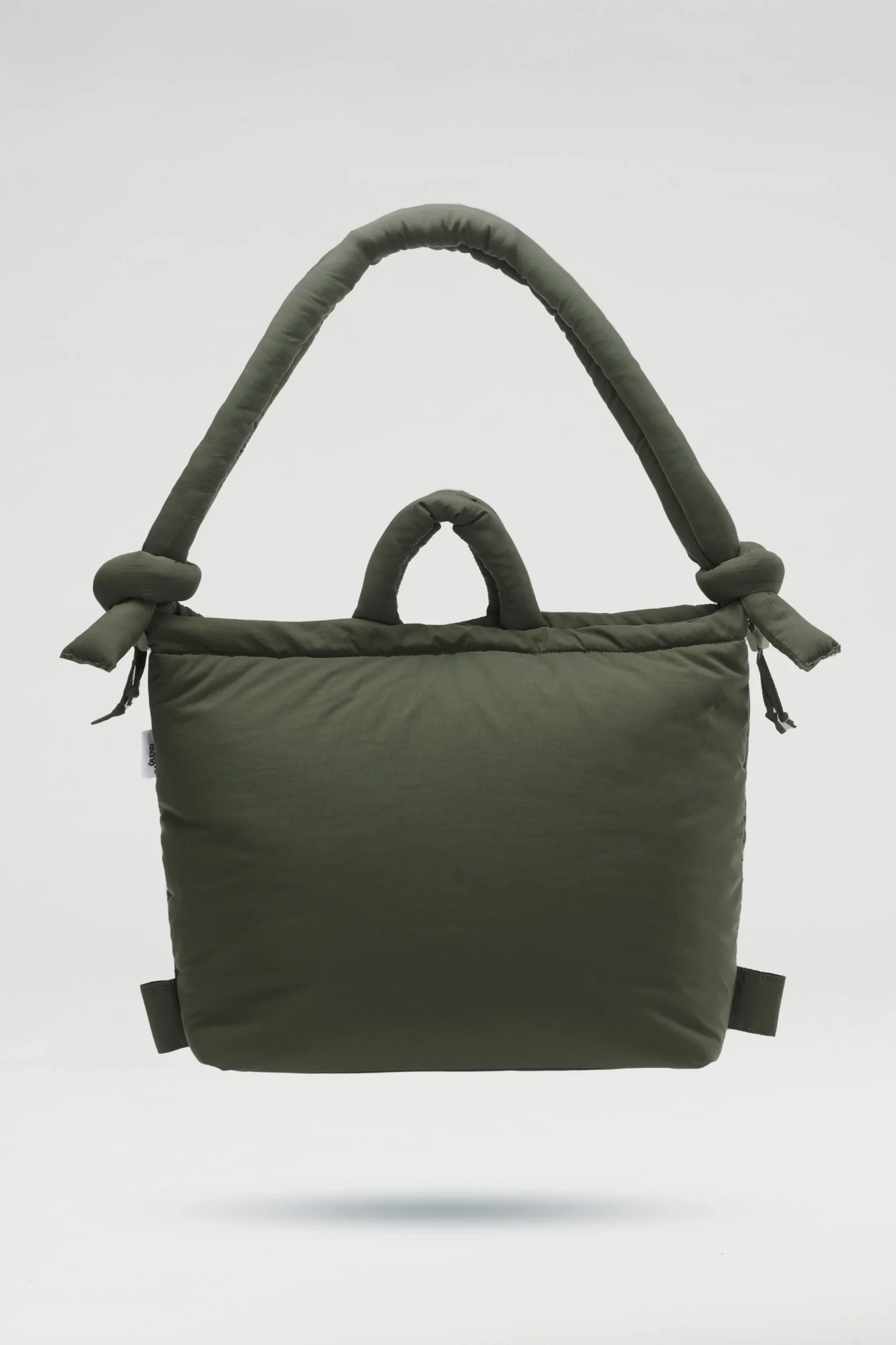 The Ona Soft Bag - Forest Green is a padded tote with a large rounded handle featuring knot details and a smaller centre handle—ideal for shopping in Tallinn or as a distinctive gift, shown on a plain white background. Gate21.ee