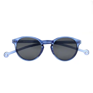 The "Isla" Blue Sunglasses feature round, translucent blue frames and dark lenses, accented by small circular holes near the temple ends. Showcasing Estonian design, they're a standout choice against a white background for any gift shop. Gate21.ee