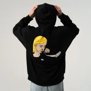 A person in a Coconerm Hoodie Black, hood up and facing away, shows off the Estonian design: a graphic of a blonde woman using a rolled note and a cartoon cat holding a white line on the back. Gate21.ee