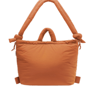 The Ona Soft Bag - Oxide is a large, rectangular, padded orange tote with two handles—one short and one long, each knotted at the ends—shown against a plain white background for a curated concept shop look. Gate21.ee