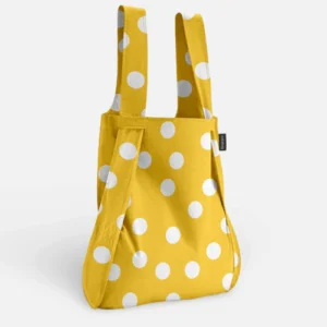 The Golden Dots - Notabag is a yellow reusable shopping bag with white polka dots, two sturdy handles, and a small black label—reflecting Estonian design and ideal for gift shop collections. Gate21.ee