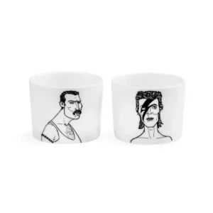 The Legends Espresso set: two white ceramic cups with black line art inspired by iconic figures—one with short hair and moustache, the other with styled hair and a lightning bolt. A unique Estonian design for your gift shop. Gate21.ee