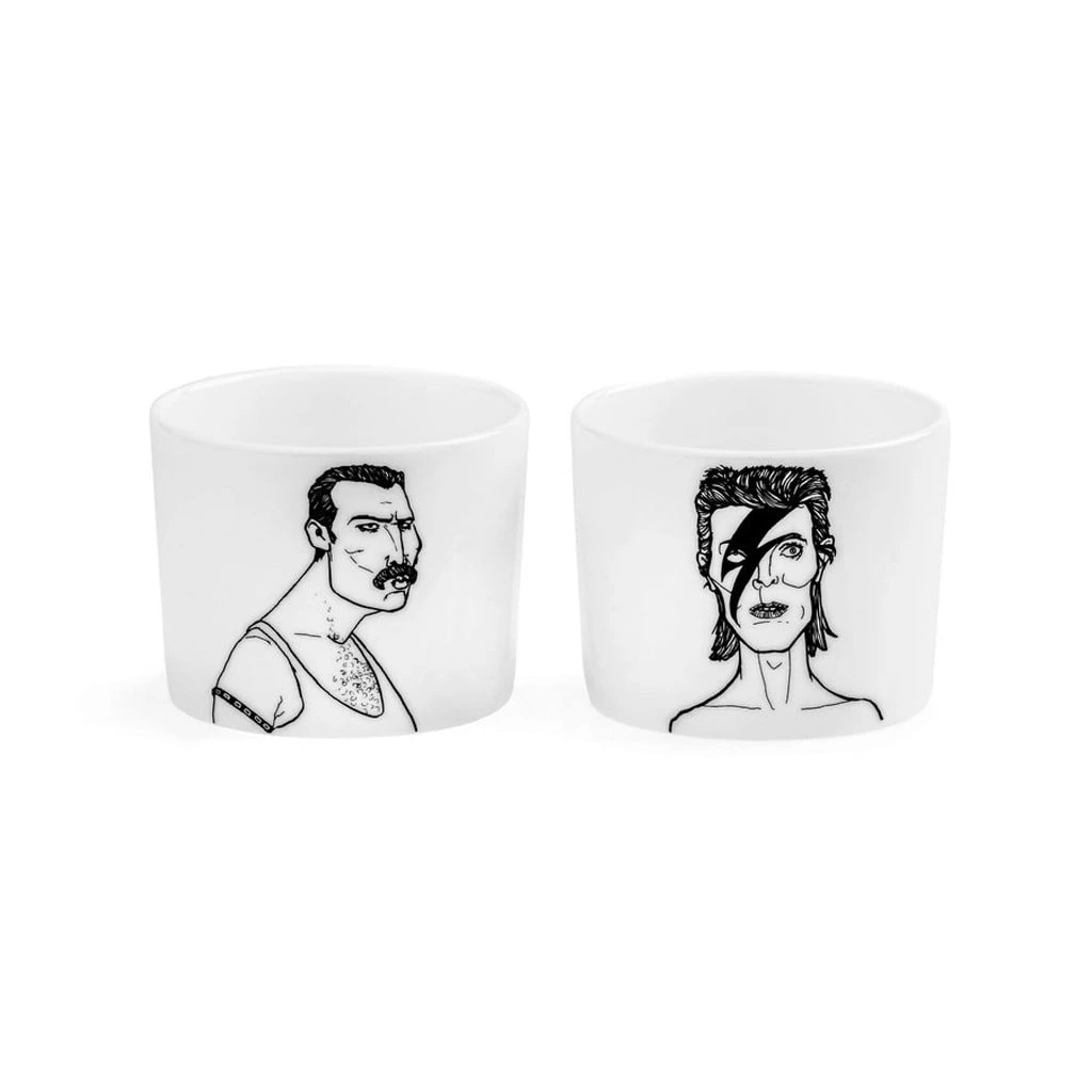 The Legends Espresso set: two white ceramic cups with black line art inspired by iconic figures—one with short hair and moustache, the other with styled hair and a lightning bolt. A unique Estonian design for your gift shop. Gate21.ee