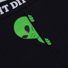 A curated graphic of a green alien peeking from behind black Same Shit Different Day Boxers, with partial white text at the top—an eye-catching piece perfect for any gift shop or fan of Estonian design. Gate21.ee