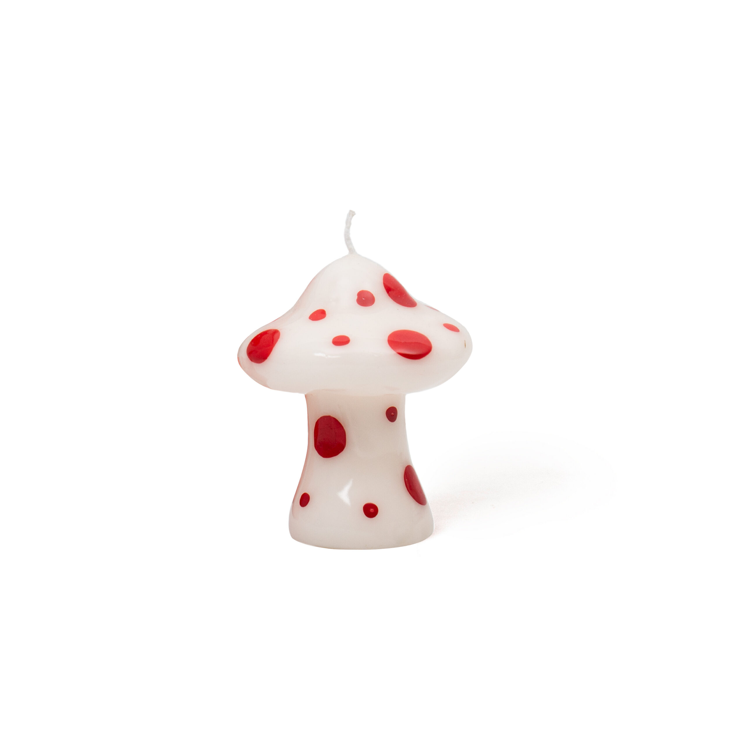 The Mushroom Candle - White features a curated mushroom shape with a white base and red spots, plus a wick on top. Perfect for unique décor ideas and shown against a plain white background. Gate21.ee