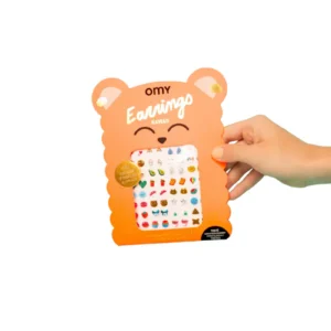 A hand holds an orange, bear-shaped package labelled Kawaii - Earring Stickers, showing multiple pairs of colourful, stick-on earrings with cute designs—ideal for gift shop lovers looking for unique ideas. Gate21.ee