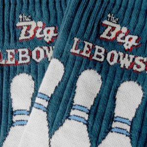 Close-up of teal knitted fabric featuring white bowling pins and "Back to the Future - Athletic" in a retro font—a quirky Estonian design perfect for fans or as a unique concept shop find. Gate21.ee