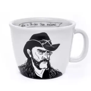 The hoarse-voiced Cowboy - Big cup is a white mug featuring a long-haired, moustached cowboy with a hat and the phrase “coffee is thicker than motor oil” inside—an original Tallinn gift shop idea for unique shoppers. Gate21.ee