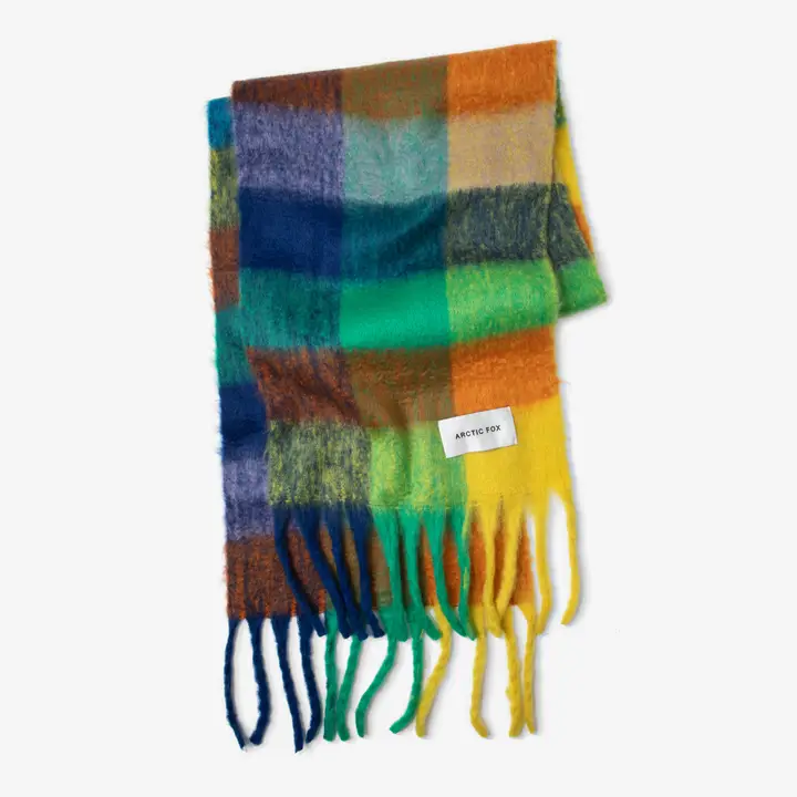 The Reykjavik Scarf - Nordic Skies is a multicoloured, fuzzy chequered scarf in blue, green, yellow, orange, and brown with long fringes and a white ARCTIC FOX label. Gate21.ee